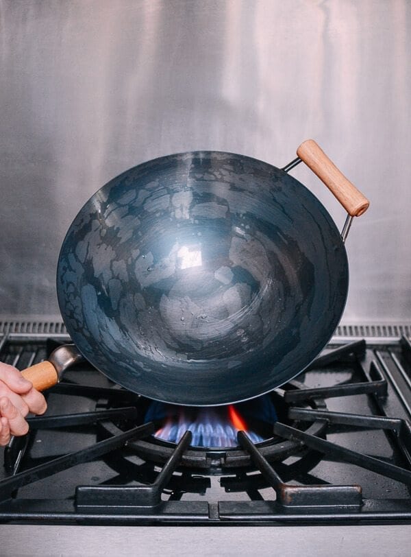 Drying a wet wok over heat